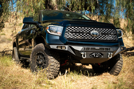 Winch  front bumper mounted to a Tundra in a field.