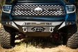 Up close image of spec series Tundra bumper equipped with  a 20-inch light bar, two D-rings, and a winch.