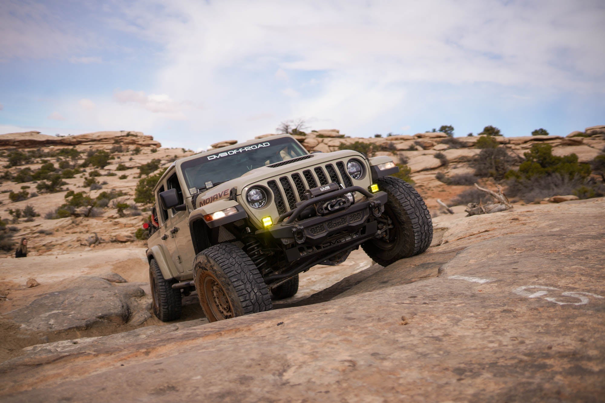 A Jeep JT venturing off-road with DV8 Offroad upgrades.