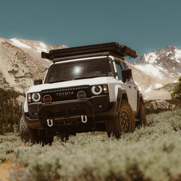 A Land Cruiser venturing off-road with a DV8 Roof Rack.