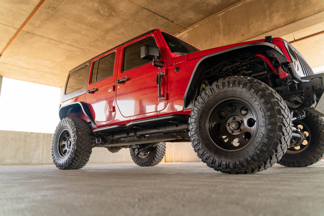 Low-angle shot of the OE Plus Side Steps for the 2007-2018 4-Door Jeep Wrangler JK