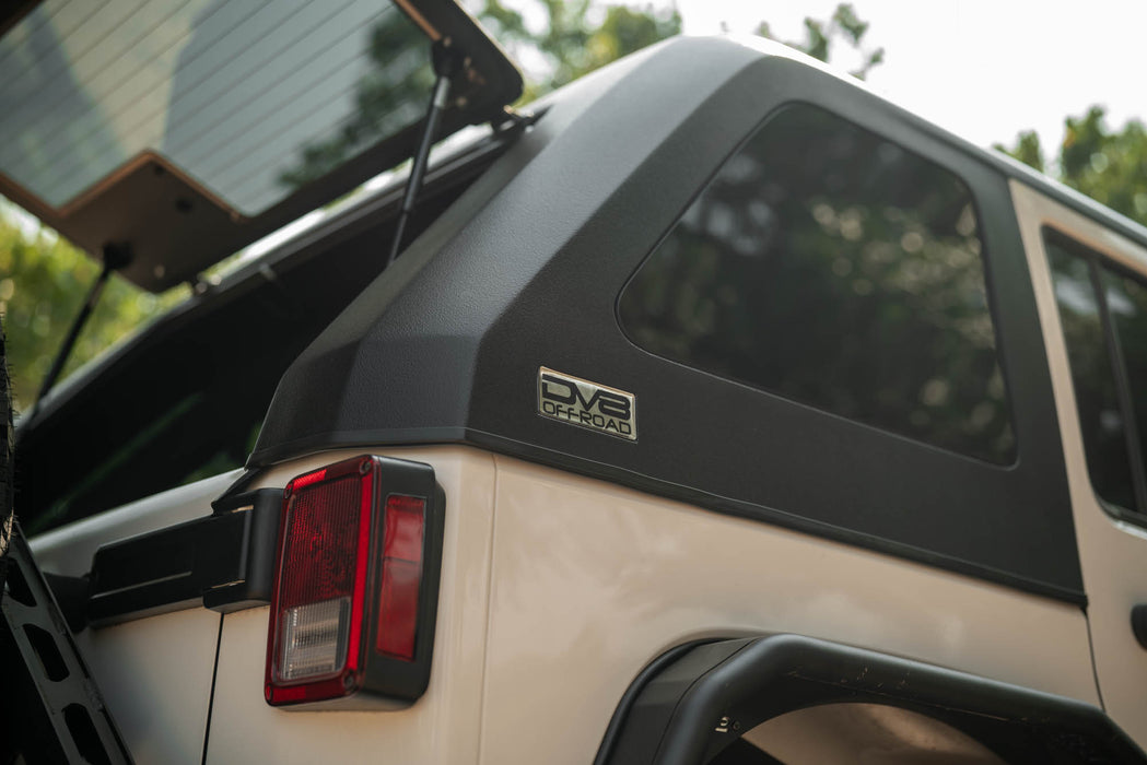 Back of 2007-2018 Jeep JK 4-Door with DV8 Fastback Hard Top on a blurred natural background