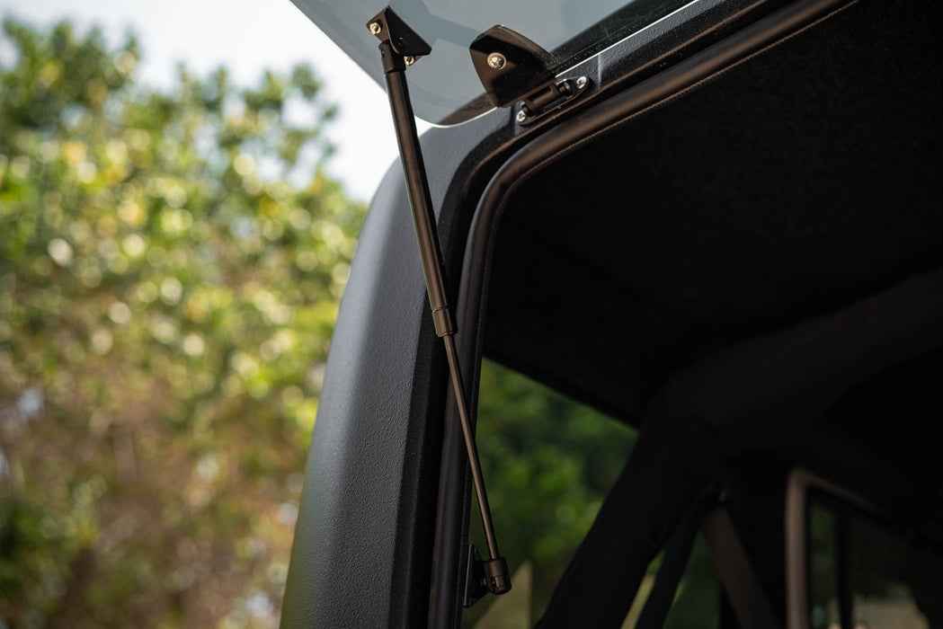 Close-up of 2007-2018 Jeep JK 4-Door with DV8 Square Back Hard Top with open rear window with a blurred natural background