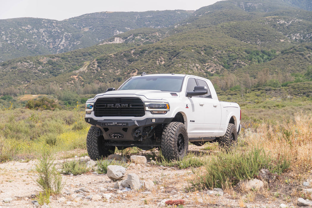 Spec Series Front Bumper for the 2019-2026 Ram 2500/3500 on a rocky terrain with mountains in the background