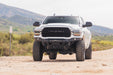 Spec Series Front Bumper for the 2019-2026 Ram 2500/3500 on a dirt road with mountains in the background