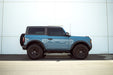 Vehicle profile view with the 2021-2023 Ford Bronco 2-Door Pinch Weld Covers and steps installed