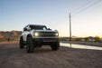 Ford Bronco parked on a dirt road with mountains in the background, Competition Series.