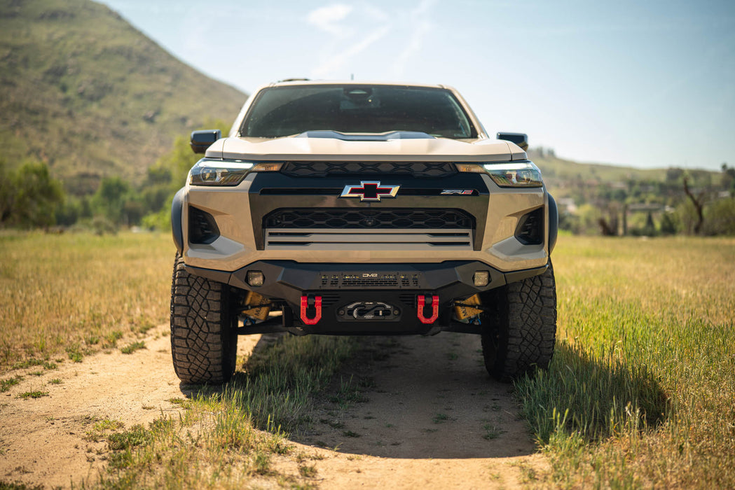 Chevrolet truck on a dirt road with mountains in the background. Chevy Colorado ZR2 Spec Series Front Bumper Installed