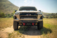Chevrolet truck on a dirt road with mountains in the background. Chevy Colorado ZR2 Spec Series Front Bumper Installed
