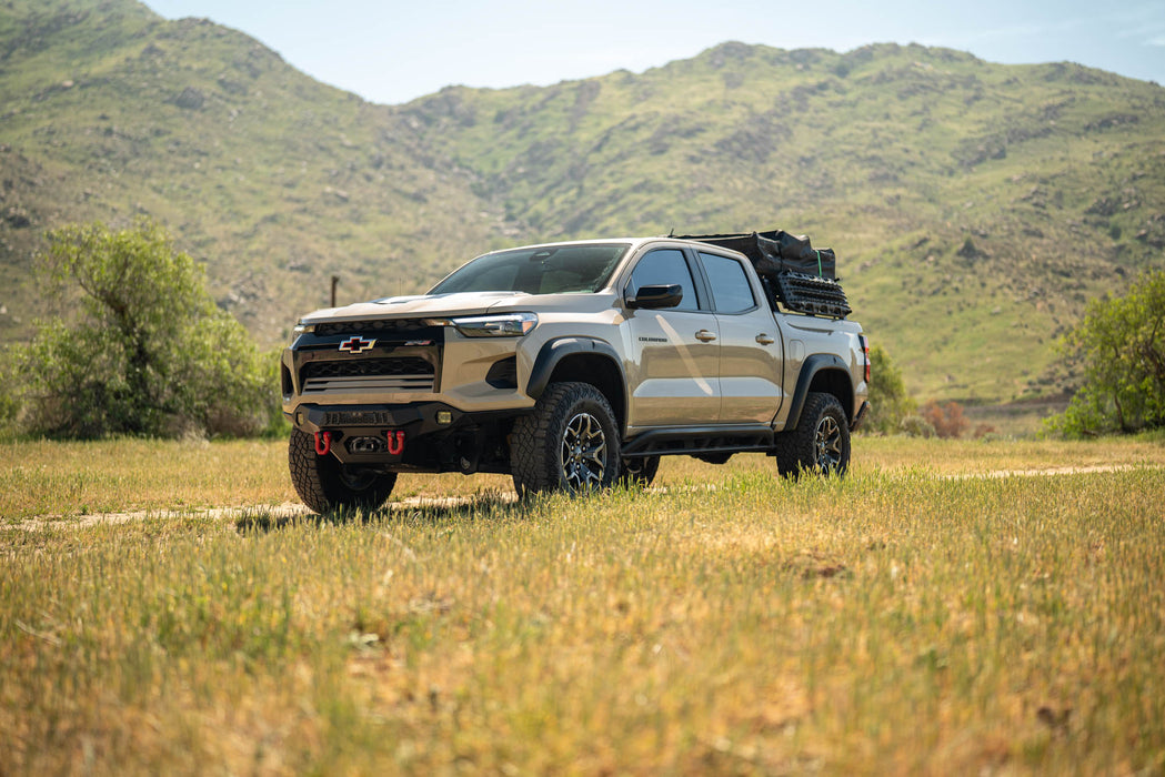 Chevy Colorado ZR2 with Spec Series Front Bumper in a field with mountains in the background