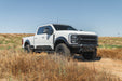 Ford F-250/350 Spec Series Front Bumper on white pickup truck on a dirt road with a clear blue sky