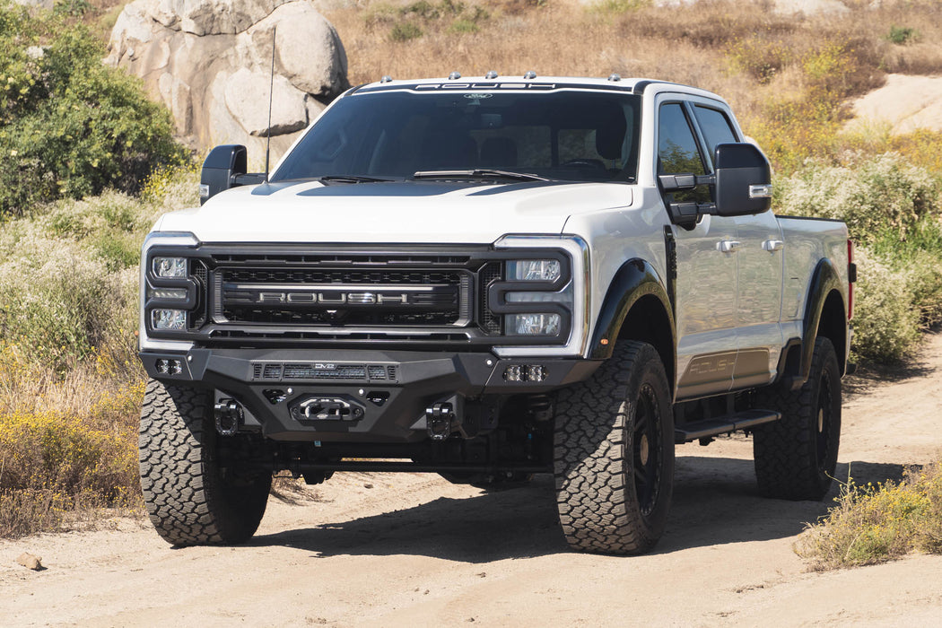 White Super Duty with the Ford F-250/350 Spec Series Front Bumper on a dirt road with rocky and desert landscape