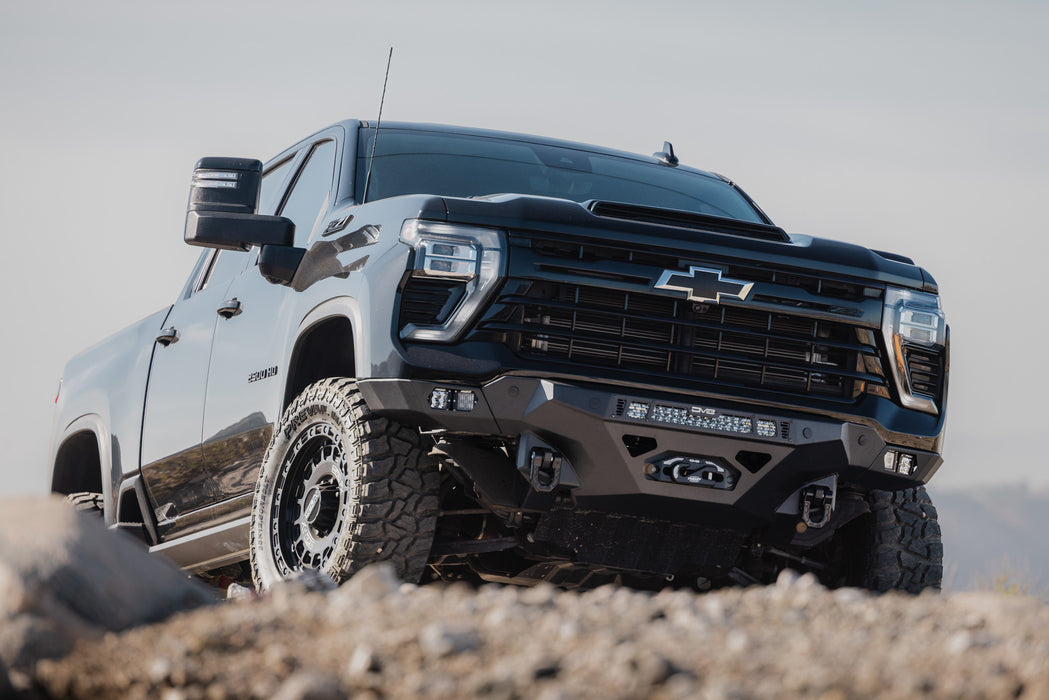 2024-2026 Chevy Silverado 2500/3500 with Spec Series Front Bumper on a rocky terrain with a clear sky.