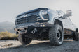 2024-2026 Chevy Silverado 2500/3500  with our Spec Series Front Bumper on a dirt road with mountains in the background
