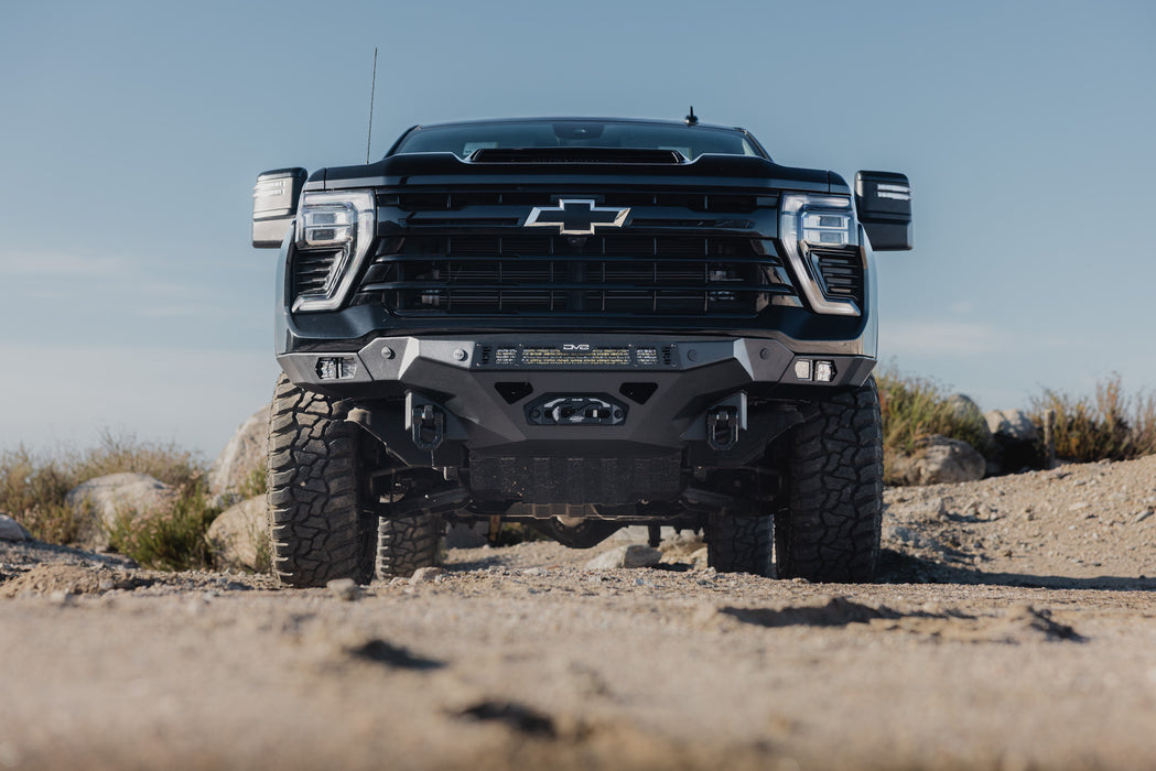 2024-2026 Chevy Silverado 2500/3500  with our Spec Series Front Bumper on a rocky terrain with a clear sky