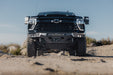 2024-2026 Chevy Silverado 2500/3500  with our Spec Series Front Bumper on a rocky terrain with a clear sky