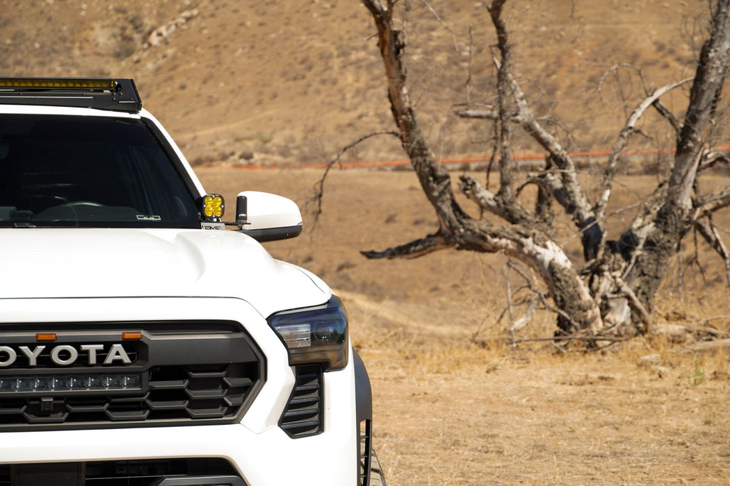 4th Gen Toyota Tacoma Ditch Light Brackets on Toyota Tacoma on a dirt road with a desert landscape