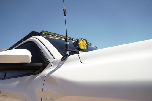 4th Gen Toyota Tacoma Ditch Light Brackets with a light and antenna against a clear blue sky