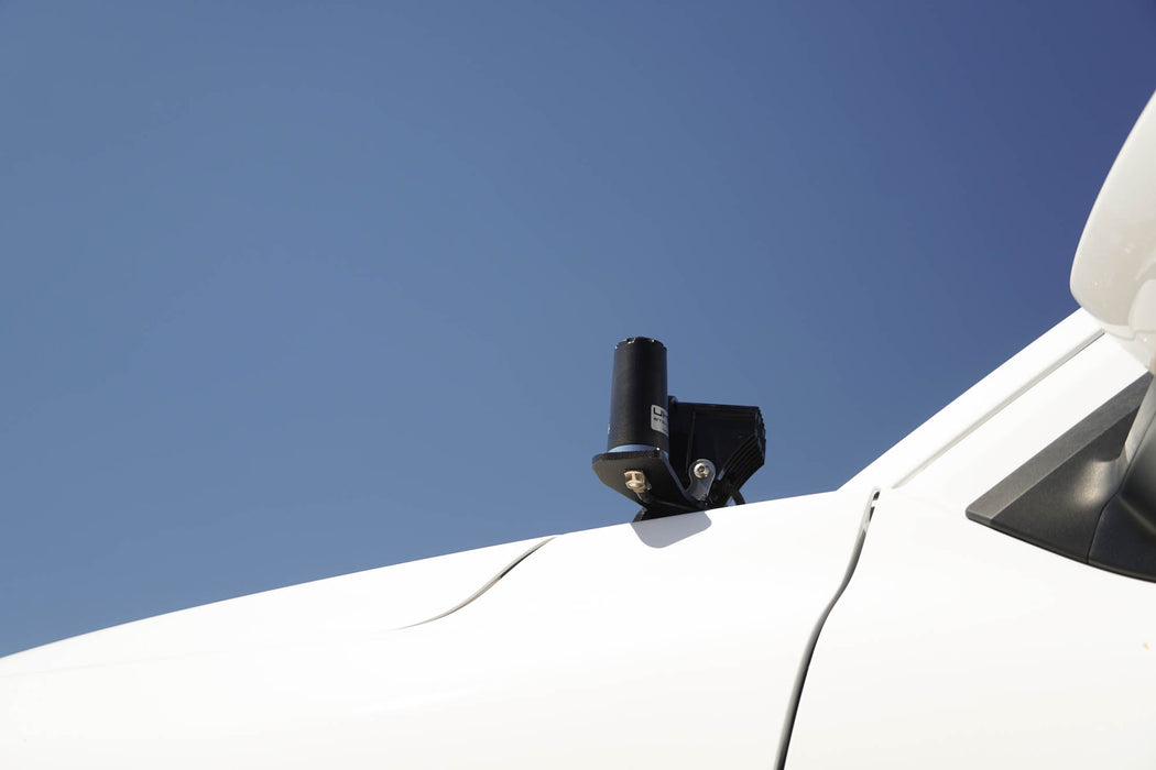 4th Gen Toyota Tacoma Ditch Light Brackets on a white Tacoma against a clear blue sky