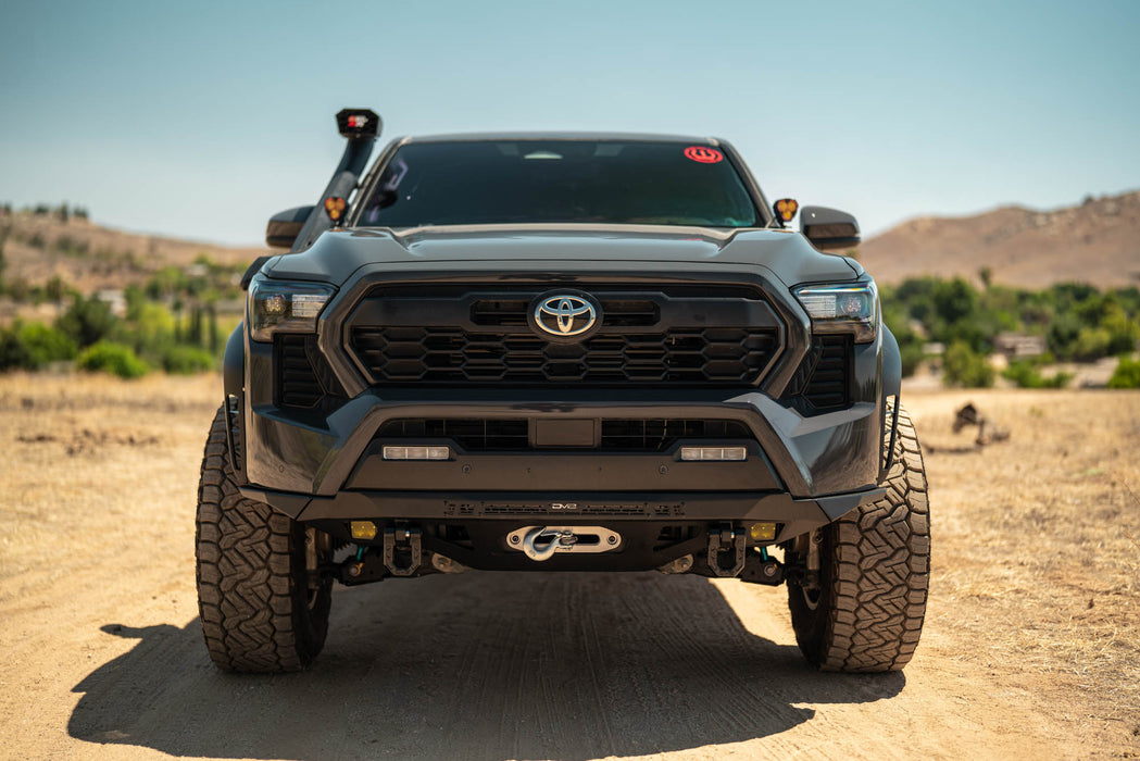 Spec Series Front Bumper on the 4th Gen Toyota Tacoma on a dirt road with a clear sky