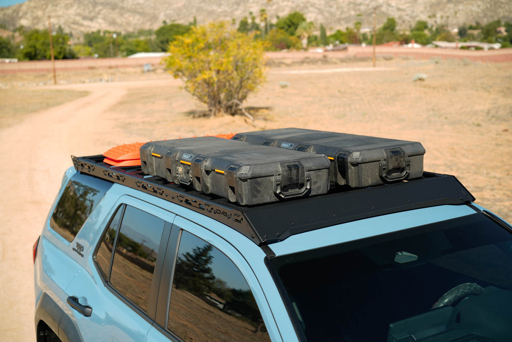 Two large gray cases on a Spec Series Roof Rack for 6th Gen Toyota 4Runner with a desert landscape in the background