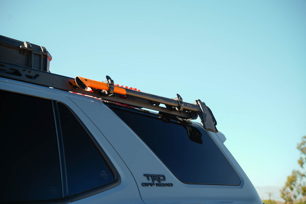 Axe mounted to the side panels of the Spec Series Roof Rack for 6th Gen Toyota 4Runner