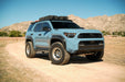 Blue Toyota 4Runner with off-road tires and a 6th Gen Spec Series Roof Rack in a desert landscape