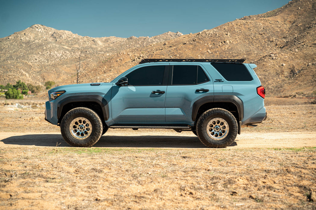 Blue 6th Gen Toyota 4Runner with Roof Rack Light Cutout installed parked on a dirt road with mountains in the background