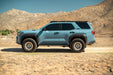 Blue 6th Gen Toyota 4Runner with Roof Rack Light Cutout installed parked on a dirt road with mountains in the background