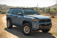 6th Gen Toyota 4Runner Roof Rack Light Cutout installed on a dirt road with a scenic background