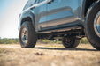 2025 Toyota 4Runner with Trailing Arm Skid Plate installed on a dirt road with a blurred natural background