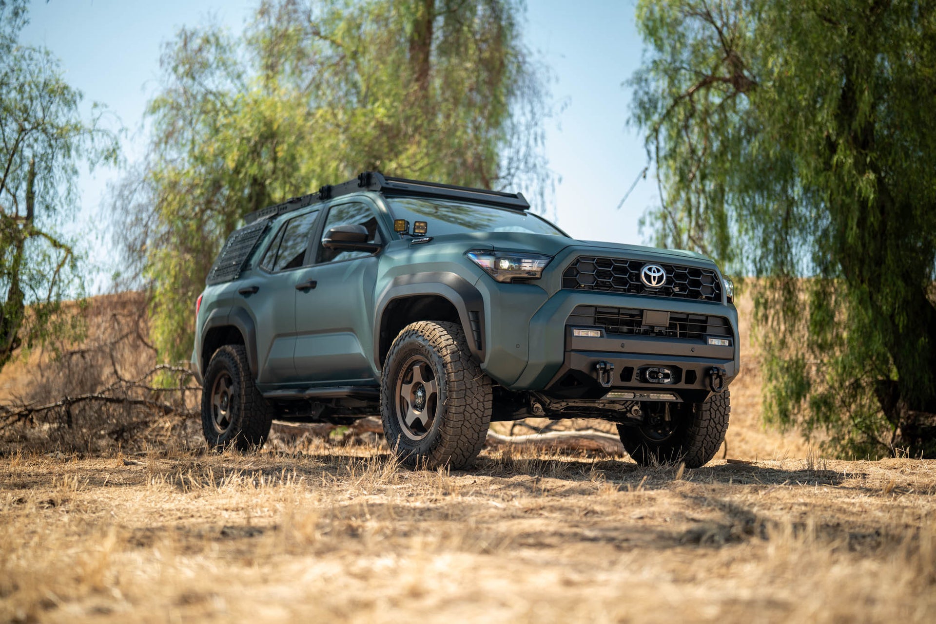 6th Gen Toyota 4Runner Centric Winch Front Bumper in a natural setting with trees and clear sky