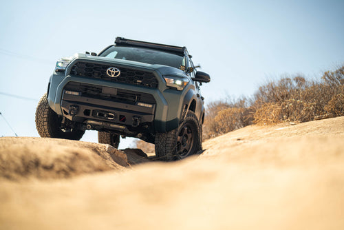 6th Gen Toyota 4Runner Centric Winch Front Bumper, driving on a sandy dune with a clear sky