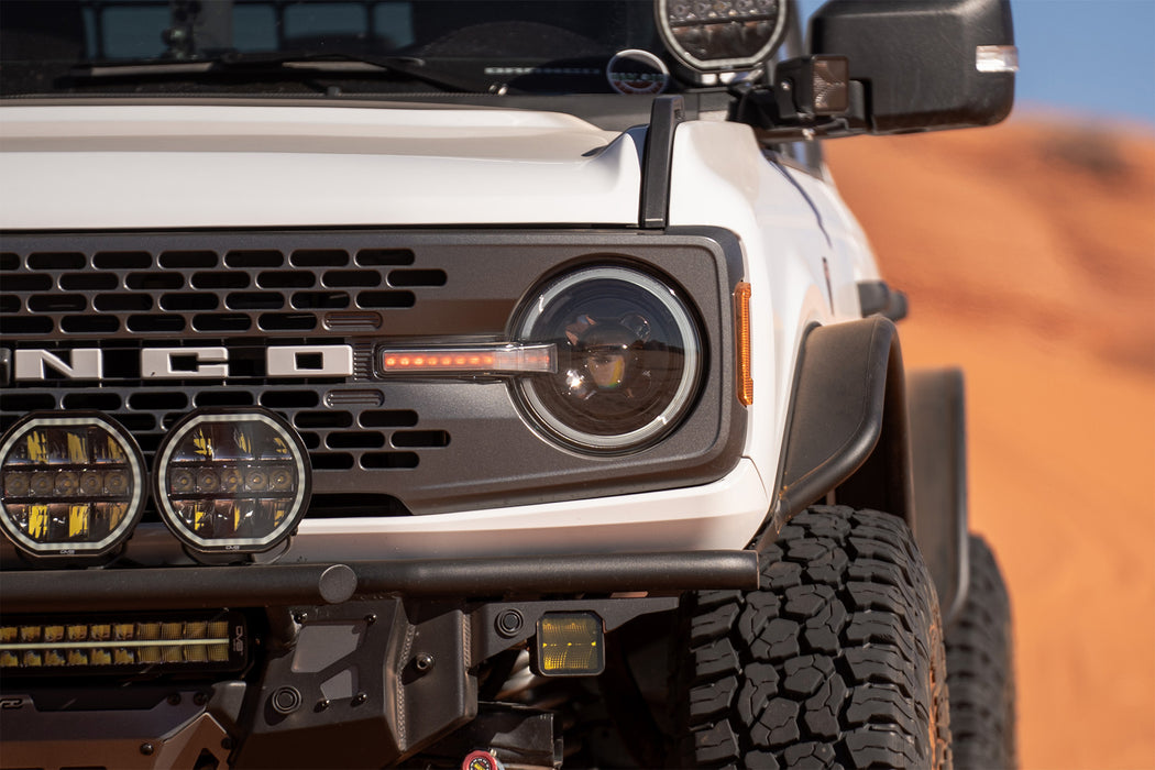 Detailed view of Ford Bronco Black Headlights in red desert setting.