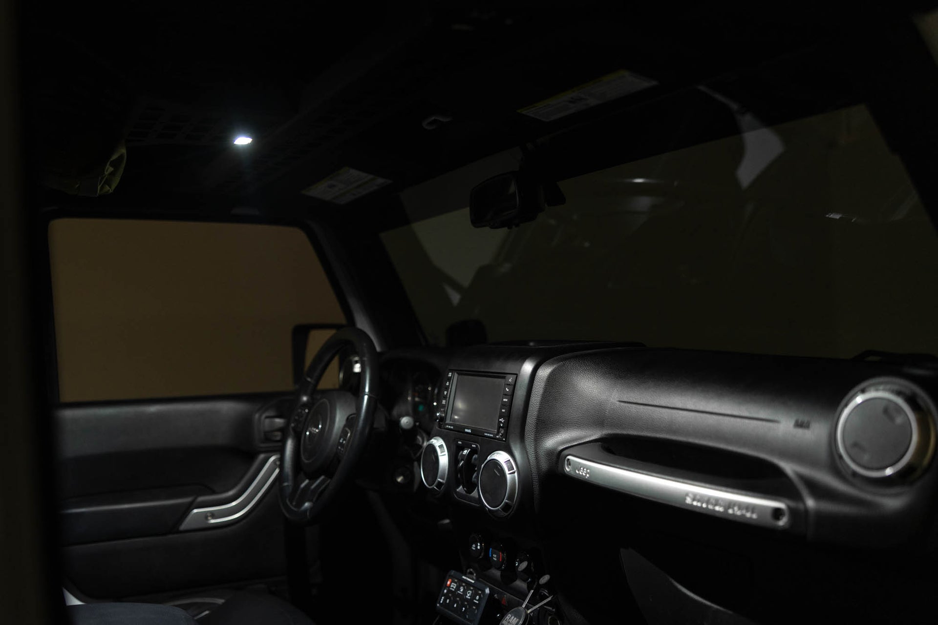 Interior of Jeep with Elite White Push Button Dome Light installed to overhead molle console