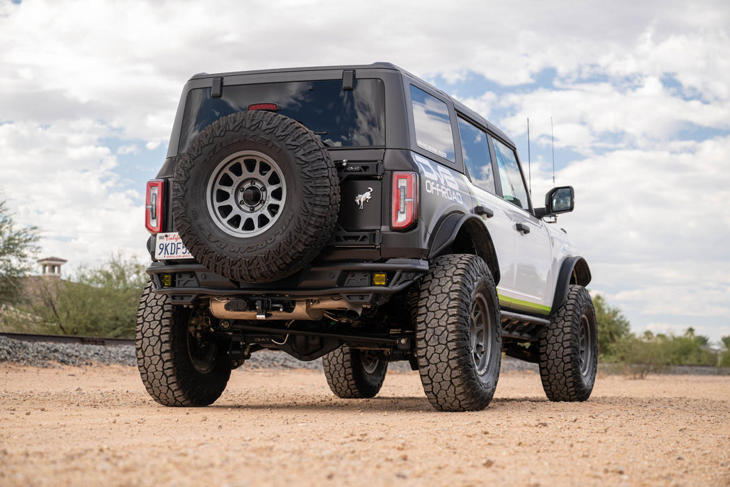 Off-road Ford Bronco Rear Tube Bumper installed, on a dirt road with a cloudy sky in the background