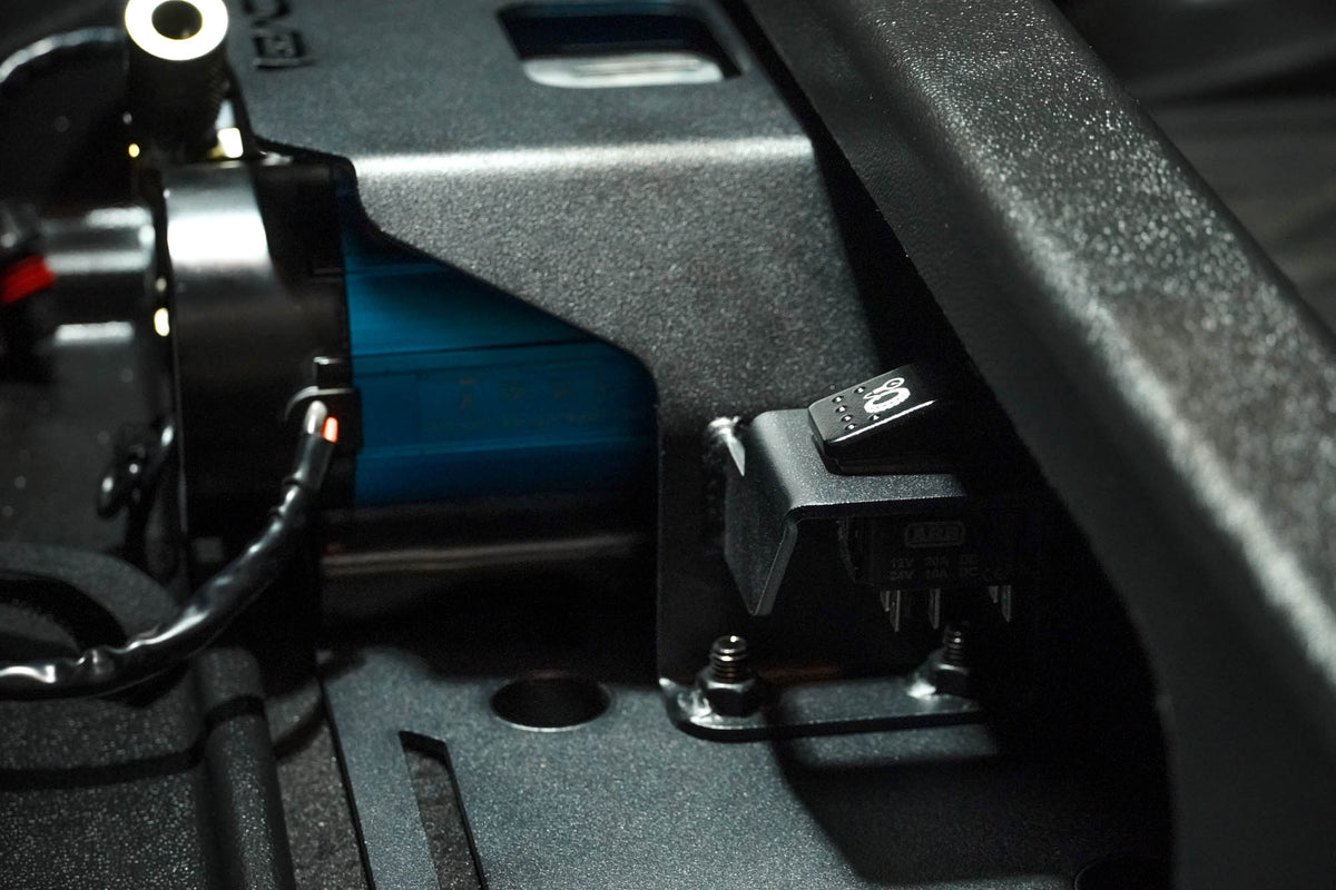 Installed 2023+ Colorado/Canyon Rear Seat Air Compressor Mount with focus on rocker switch used in cutout for rocker switches
