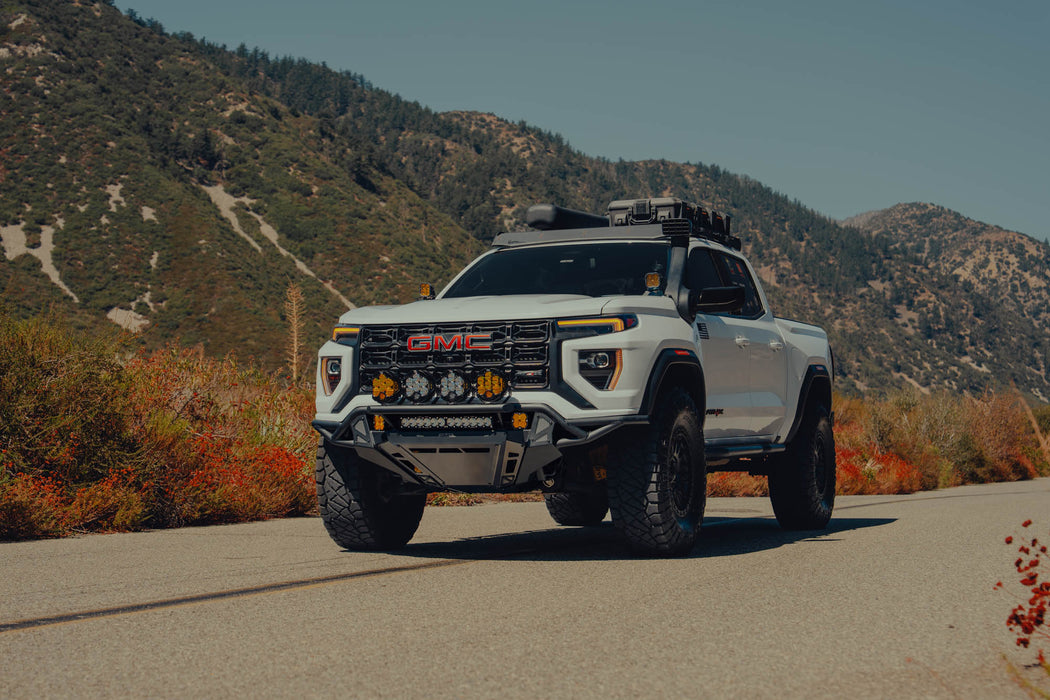 GMC Canyon Tube Front Bumper installed on truck driving on the road with fall scenery