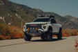 GMC Canyon Tube Front Bumper installed on truck driving on the road with fall scenery
