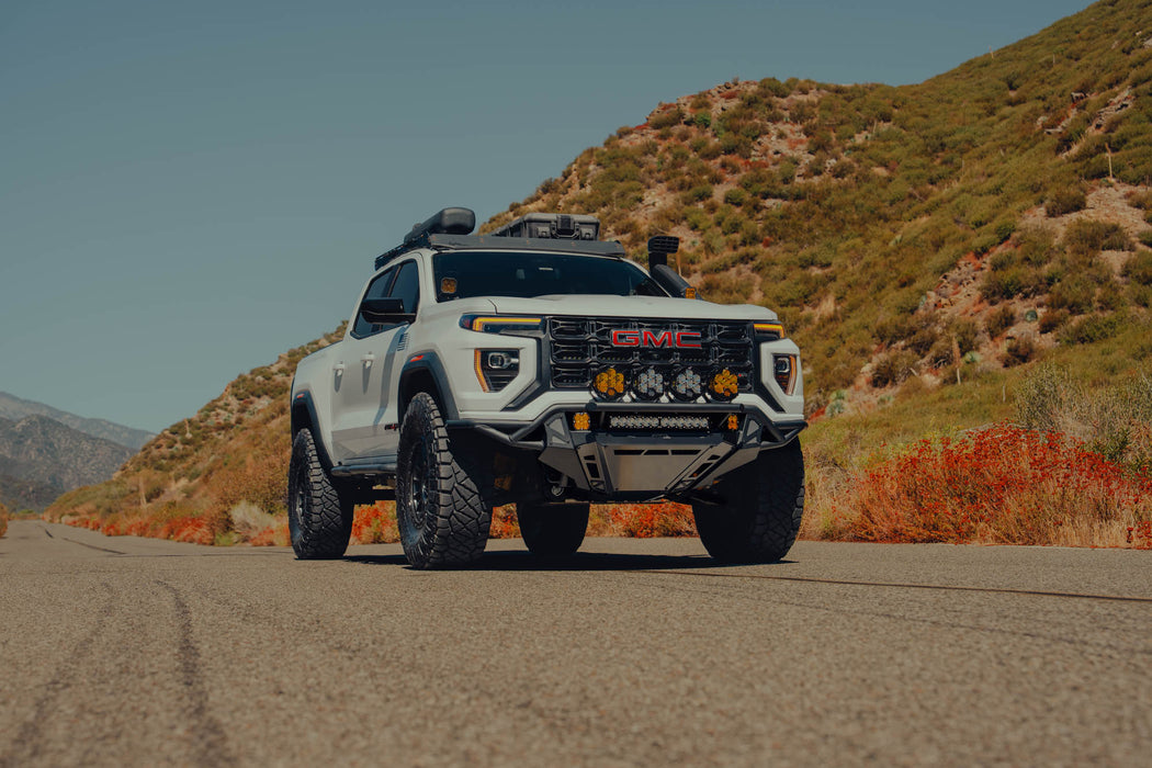 GMC Canyon Tube Front Bumper installed on off road rig with ultra-high clearance and integrated skid plate