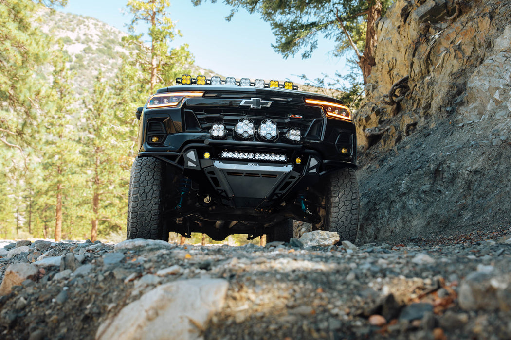 Low-angle view of high-clearance 2023+  Chevy Colorado Tube Front Bumper installed on  Trail Boss on the trail 