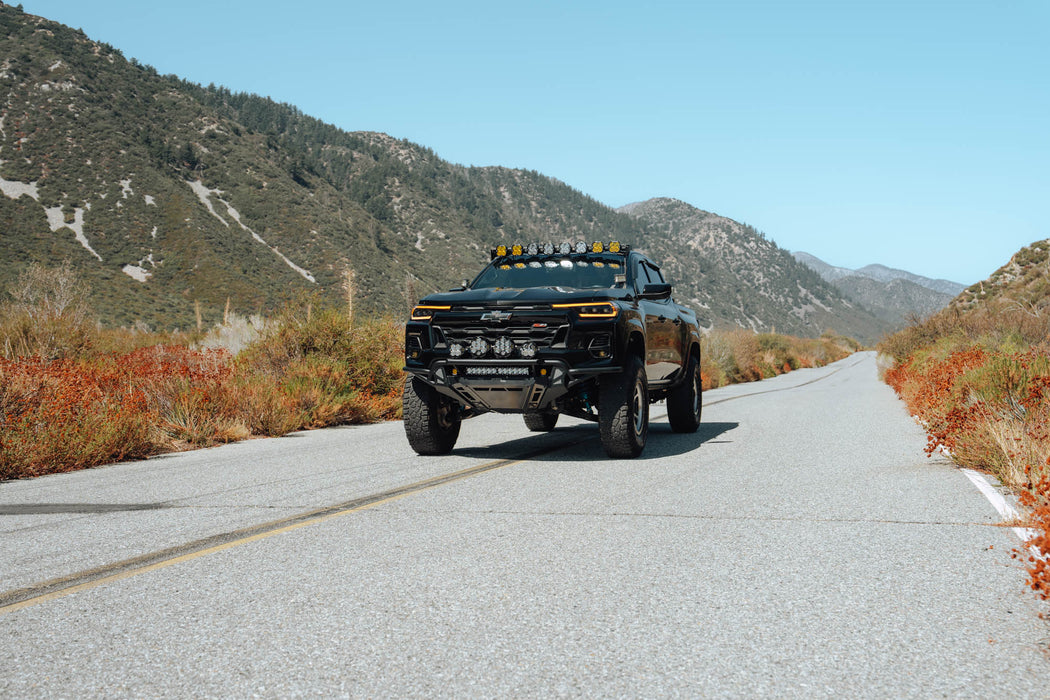 Angled view of Chevy Colorado Trailboss with 2023+ Chevy Colorado Tube Front Bumper installed with auxiliary lighting