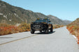 Angled view of Chevy Colorado Trailboss with 2023+ Chevy Colorado Tube Front Bumper installed with auxiliary lighting