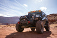 Black Jeep Wrangler JK in a desert landscape with mountains in the background