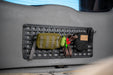 Universal Molle Panel with tactical pouches and a gear inside a vehicle.