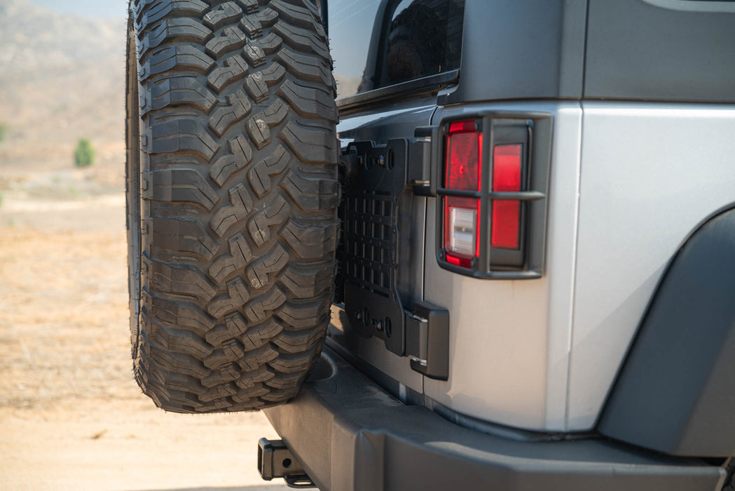 Close-up of a Jeep Wrangler JK Tailgate Reinforcement Molle Panel and  tail light with a natural outdoor background