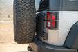 Close-up of a Jeep Wrangler JK Tailgate Reinforcement Molle Panel and  tail light with a natural outdoor background