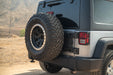 Full-sized spare tire with Jeep Wrangler JK Tailgate Reinforcement Molle Panel installed.