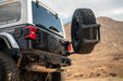 Off-road 2018-2025 Jeep Wrangler JL Body Mounted Tire Carrier in a desert setting