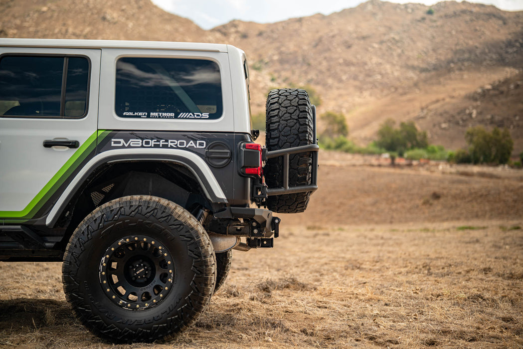 Off-road 2018-2025 Jeep Wrangler JL Body Mounted Tire Carrier in a desert landscape